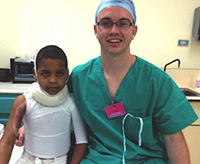 Farrell Sheehan with a burn patient in the Dominican Republic