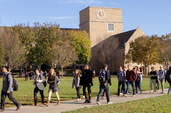 Students walk near O'Shaughnessy dressed for Fall