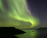 The northern lights over Kulusuk, a small island on the east coast of Greenland. Photo courtesy of Nick Russill, Flickr.