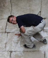 Wesley Wood touches the forum pavement in Butrint, Albania