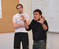 Theater professor Anton Juan works with students in a class on performance analysis