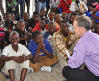 Ambassador Griffiths talking to boys at a circumcision clinic