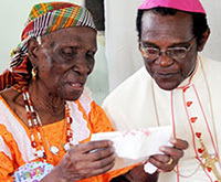 Cardinal Felix, right, talks to an elderly woman