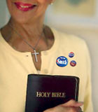 woman with Bible and campaign buttons