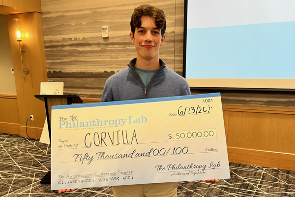 A young man holding a novelty check.