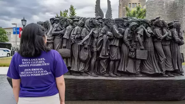 Elsy Pineda gazes at the Angels Unawares sculpture, a bronze sculpture of migrants and refugees from various lands crowded on a 20-foot boat at the Catholic University of America in Washington, D.C.