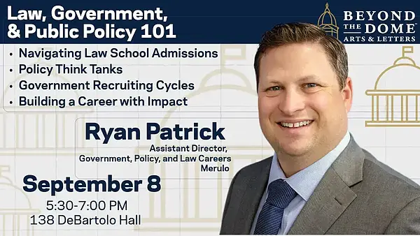 Ryan Patrick, Assistant Director, smiles broadly in a suit for an event on Law, Government & Public Policy 101.