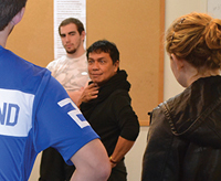 Theater Professor Anton Juan works with students in a class on performance analysis
